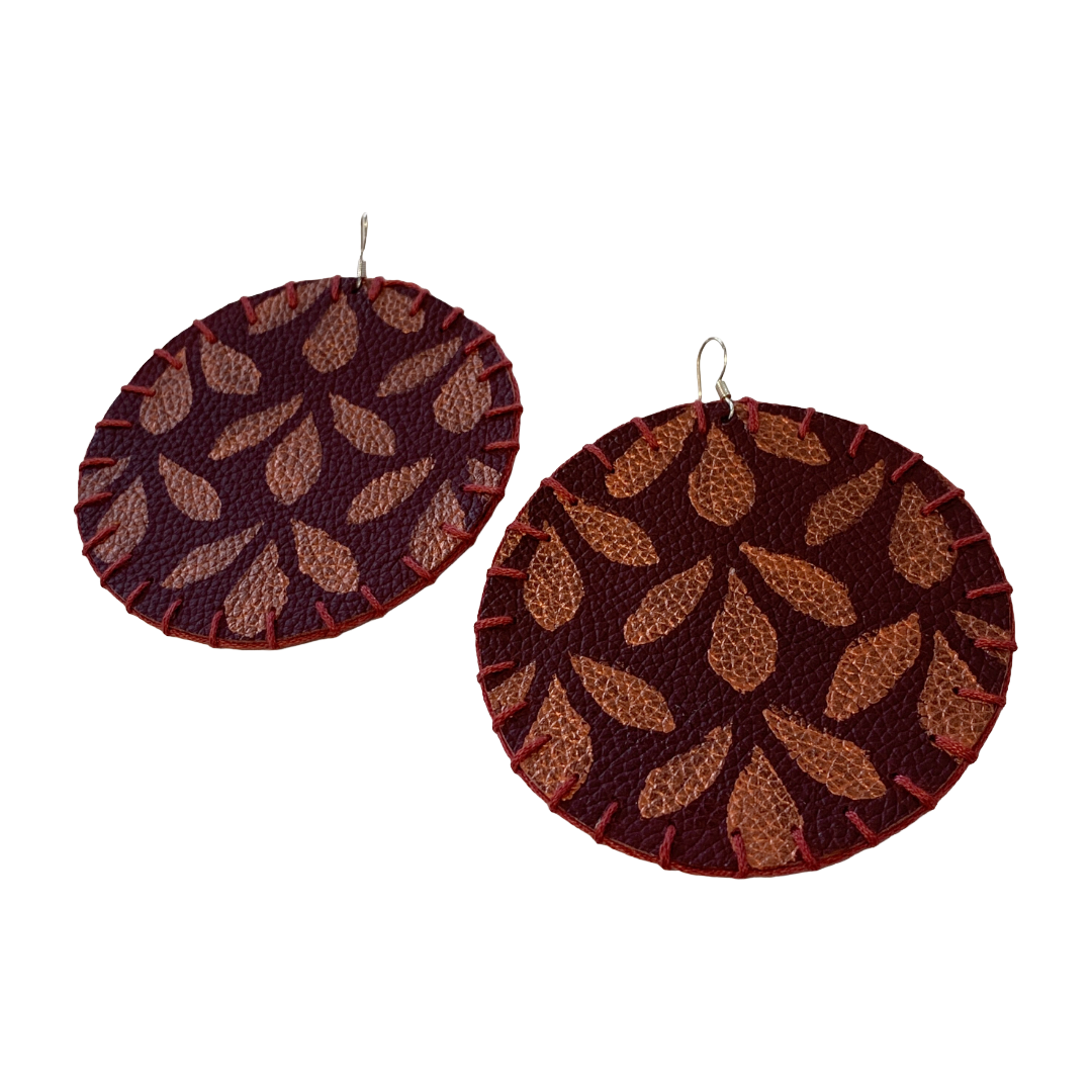 MUM'A NAI | Maxi Attraction – Amil #1 | Upcycled denim and acrylic on maroon leather with maroon cotton embroidery and sterling silver hooks | 8 (d) cm